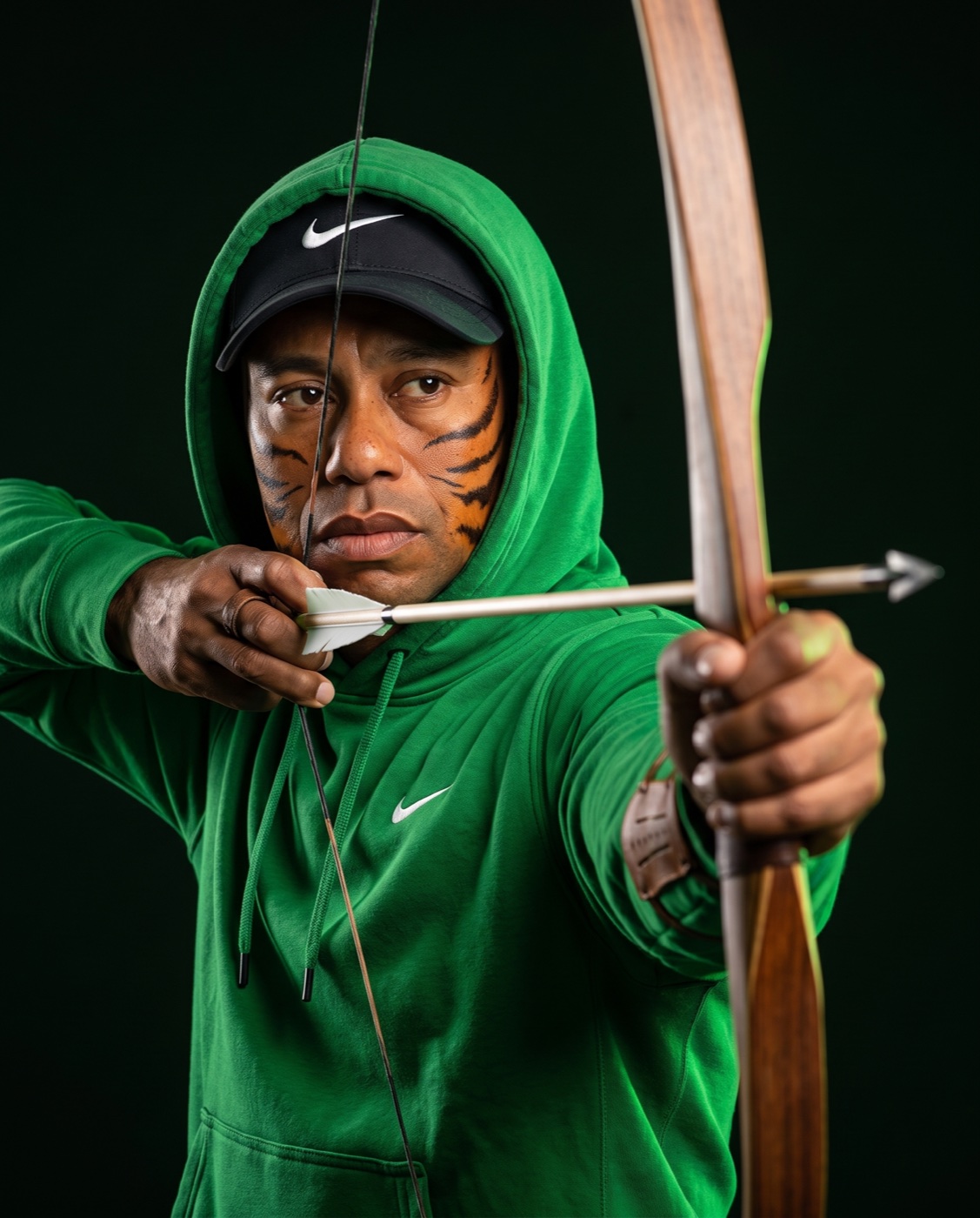Tiger Hoods at full draw on a longbow